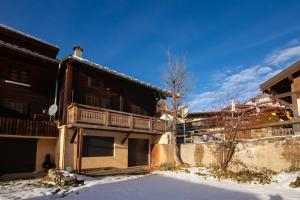a building with a balcony on the side of it at Le Chalet au Tour ski in-ski out - Happy Rentals in Chamonix