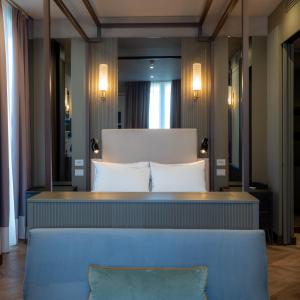 a hotel room with a bed and two pillows at The Glam Boutique Hotel & Apt in Vicenza