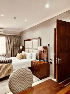 a hotel room with a bed and a couch at Hotel Destiny in Ongwediva