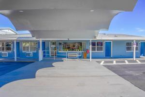 un edificio azul con un techo grande en Sunrise Inn by OYO Titusville FL, en Titusville