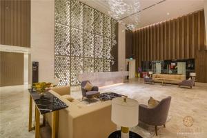 a lobby with a couch and chairs in a building at Quill City Residences KLCC in Kuala Lumpur