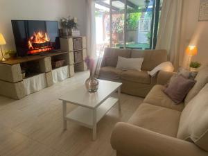 a living room with a couch and a fireplace at La casita de Mon - Radazul in Radazul