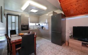 a kitchen with a dining table and a refrigerator at Nona's Central House 3bd in Zakynthos