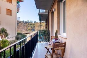 a balcony with two chairs and a table and a window at AZURE RETREAT Apartment in Camogli