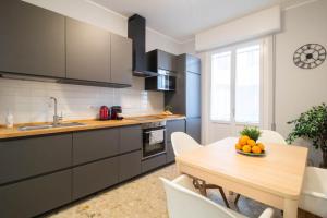 a kitchen with a wooden table and a dining room at AZURE RETREAT Apartment in Camogli