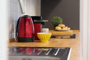 a red coffee maker sitting on a kitchen counter at AZURE RETREAT Apartment in Camogli