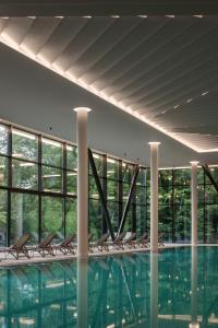 a row of chairs in a swimming pool at Verkhovyna Resort Medical & Wellness in Kamenitsa