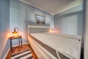 - une chambre avec un grand lit et une table de chevet dans l'établissement Ferienpark - Haus G, App 0G0602, à Heiligenhafen