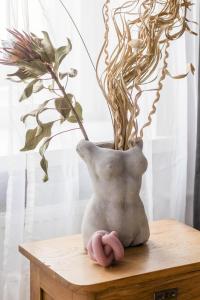 a vase sitting on a table with a plant at Artist's Dream Studio with Mezzanine by Renters in Warsaw