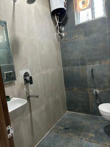 a bathroom with a shower and a toilet and a sink at Hotel Park Airport Zone Hyderabad in Shamshabad