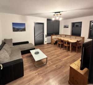 a living room with a couch and a table at FeWo Schwäbeleholz mit 2 Schlafzimmern in Sonthofen