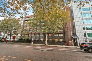 a car parked on a street in front of a building at Hububb Luxury Apartment Kensington in London