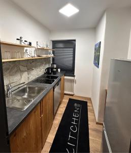 a kitchen with a sink and a counter top at FeWo Bay Schwäbeleholz mit 2 Schlafzimmern in Sonthofen