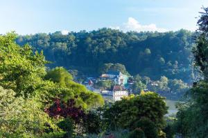 a town in the middle of a valley with trees at Castle Hill Bungalow in Kandy