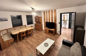a living room with a table and a couch at FeWo Schwäbeleholz mit 2 Schlafzimmern in Sonthofen