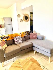 a living room with a couch with pillows on it at Tahiti Haven Lodge in Arue