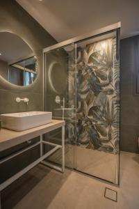 a bathroom with a sink and a shower at Arvacay Luxury Home in Malia