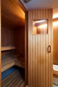 a sauna with wooden walls and a wooden door at Vienna Prestige Central Luxury Haven w Free Parking and SAUNA in Vienna