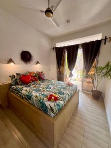 a bedroom with a large bed in a room at Gadea Boutique Hotel in Jambiani