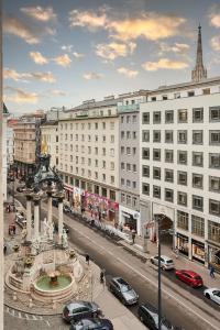 a city street with cars parked in front of buildings at Vienna Prestige Central Luxury Haven w Free Parking and SAUNA in Vienna