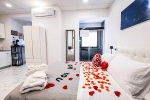 a bedroom with a bed with red hearts on it at SUITE SPACE by concept italy in Casoria