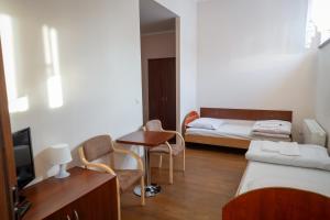 a small room with a bed and a table and chairs at Centrum Edukacyjno-Rozwojowe Wrocław Pawłowice - bezpłatny parking in Wrocław +25 photos