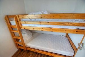 ein Etagenbett aus Holz in einem Zimmer in der Unterkunft Ferienpark - Haus H, App 0H0709 in Heiligenhafen