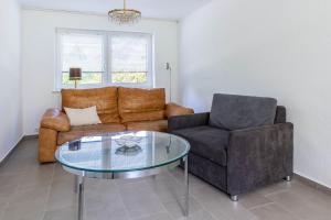 un salon avec un canapé et une table en verre dans l'établissement Ferienwohnung "Sonnenschein", à Tarnewitz