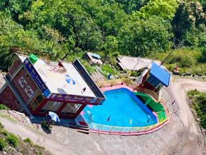 an overhead view of a swimming pool at a resort at The River Grand, Mussoorie in Mussoorie
