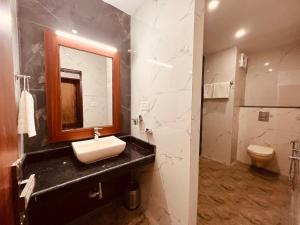 a bathroom with a sink and a toilet at The River Grand, Mussoorie in Mussoorie