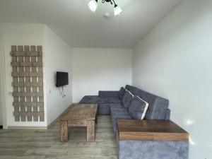 a living room with a couch and a table at Cozy 2-room apartment with views in Gudauri