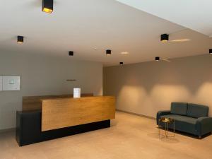 a waiting room with a chair and a reception desk at Cozy 2-room apartment with views in Gudauri