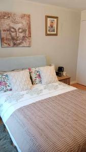 a bedroom with a large bed with pillows on it at Sunny Room near town centre in Warrenpoint