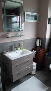 a bathroom with a sink and a toilet and a mirror at Sunny Room near town centre in Warrenpoint +3 photos
