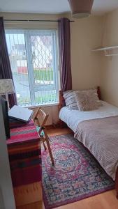 a bedroom with two beds and a desk with a laptop at Sunny Rooms near town centre in Warrenpoint