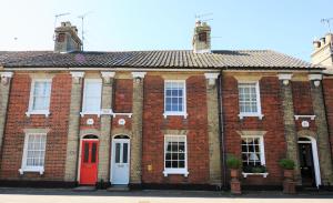 a red brick building with a red door at 33 Victoria Street in Southwold