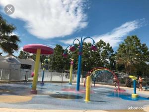 a water park with a water slide at MOBILHOME FABULEUX CAMPING VIAS PLAGE - PISCINE et SPA - 4 ETOILES in Vias