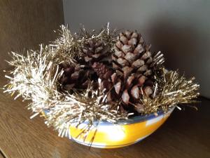 a bowl filled with pine cones and silver decorations at Apartamento Vernissa in Gandía