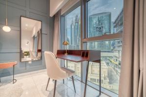 a desk in a room with a large window at Central Park Towers, DIFC - Mint Stay in Dubai