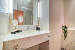 a bathroom with a sink and a mirror at Central Park Towers, DIFC - Mint Stay in Dubai