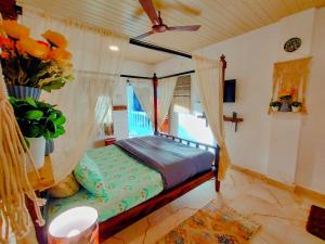 a bedroom with a bed in a room with a window at EcoZen Holiday Rooms in Agonda