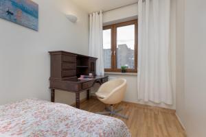 - une chambre avec un bureau, un lit et une chaise dans l'établissement Sienna Family Apartment in the Center of Warsaw by Renters, à Varsovie