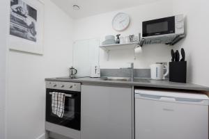 a kitchen with a sink and a stove at Stunning Central Plymouth Studio Apartment - Sleeps 2 - Habita Property in Plymouth