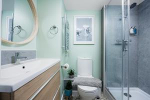 a bathroom with a toilet and a sink and a shower at Stunning Central Plymouth Studio Apartment - Sleeps 2 - Habita Property in Plymouth