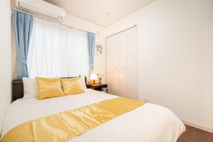 Postel nebo postele na pokoji v ubytování KYARA Hotel 浅草