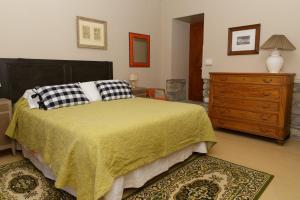 a bedroom with a large bed and a dresser at Casa Pini Rio_B in Riolunato