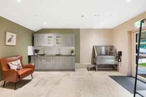 a kitchen with a couch and a chair in a room at Rock Mill 28 in Stony Middleton