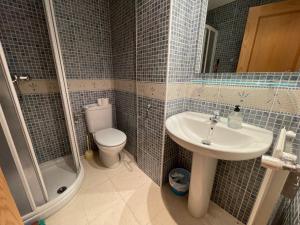 a bathroom with a toilet and a sink and a shower at Soldeu Paradis Pleta 2 in Soldeu +11 photos