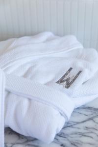 a white shirt with a picture on it sitting on a bed at Wherewithal Luxury Suites in Carlton