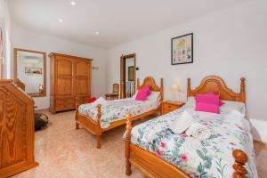 a bedroom with two beds with pink pillows at Villa Manresa in Alcudia by JS Villas in Alcudia +17 photos